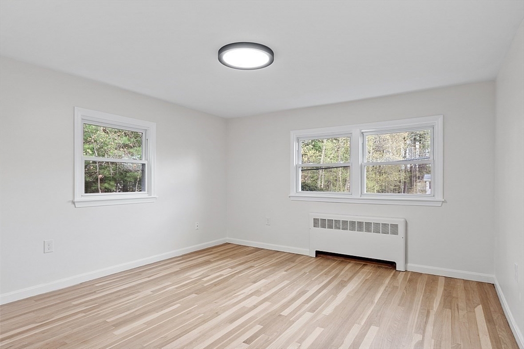 31 Pine Hill Road Chelmsford, MA 01824 - Photo 19 of 42 a view of an empty room with wooden floor and a window