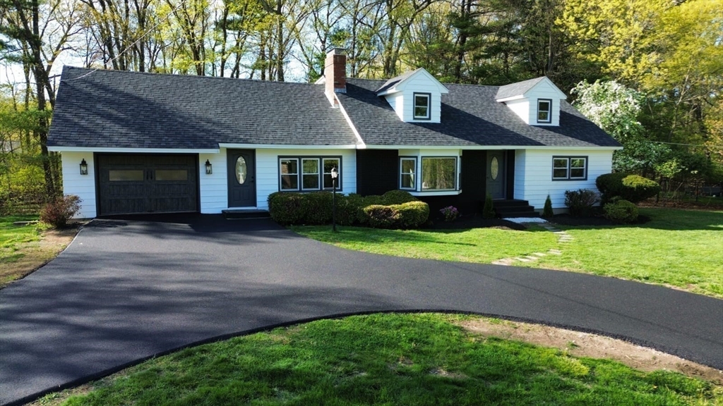 31 Pine Hill Road Chelmsford, MA 01824 - Photo 2 of 42 a front view of a house with a yard and trees