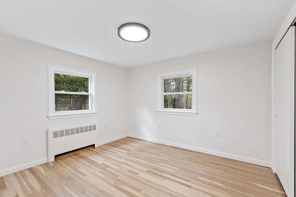 31 Pine Hill Road Chelmsford, MA 01824 - Photo 21 of 42 a view of an empty room with wooden floor and a window
