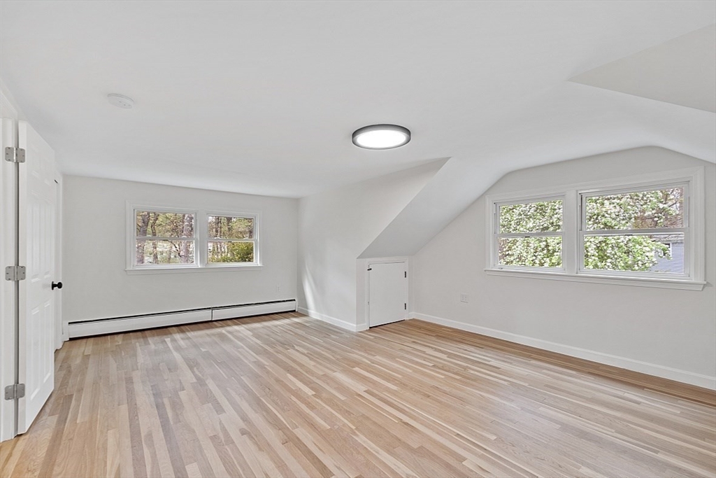 31 Pine Hill Road Chelmsford, MA 01824 - Photo 24 of 42 a view of an empty room with wooden floor and a window