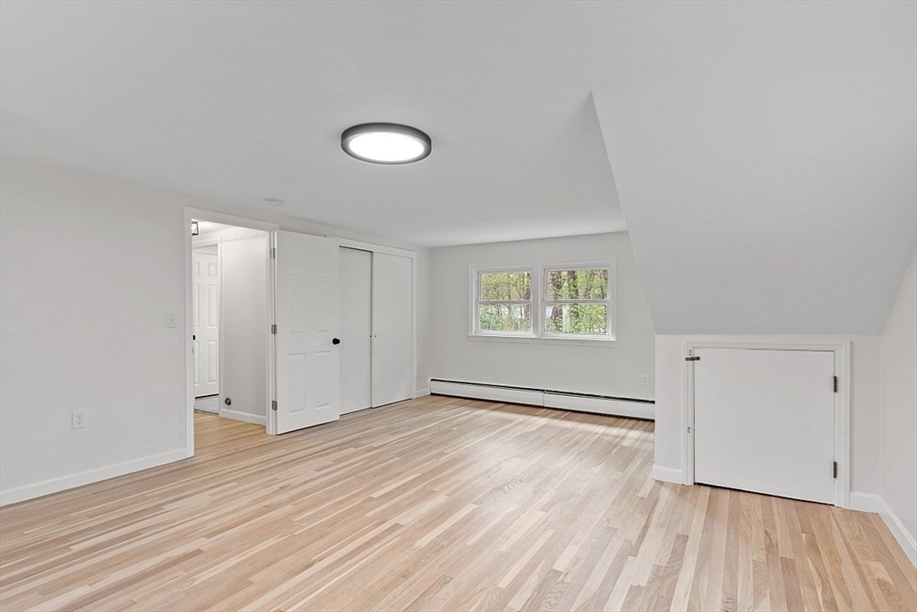 31 Pine Hill Road Chelmsford, MA 01824 - Photo 25 of 42 an empty room with wooden floor and windows
