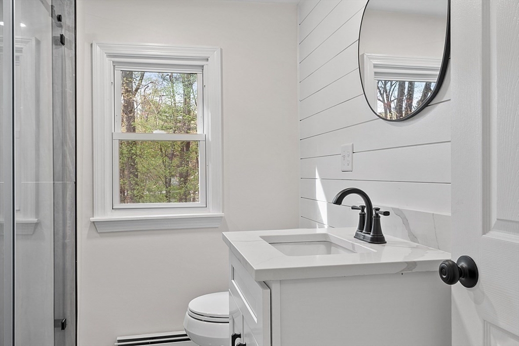31 Pine Hill Road Chelmsford, MA 01824 - Photo 27 of 42 a bathroom with a toilet sink and mirror