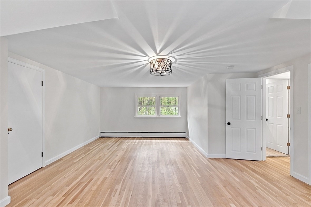 31 Pine Hill Road Chelmsford, MA 01824 - Photo 28 of 42 wooden floor in an empty room with a window