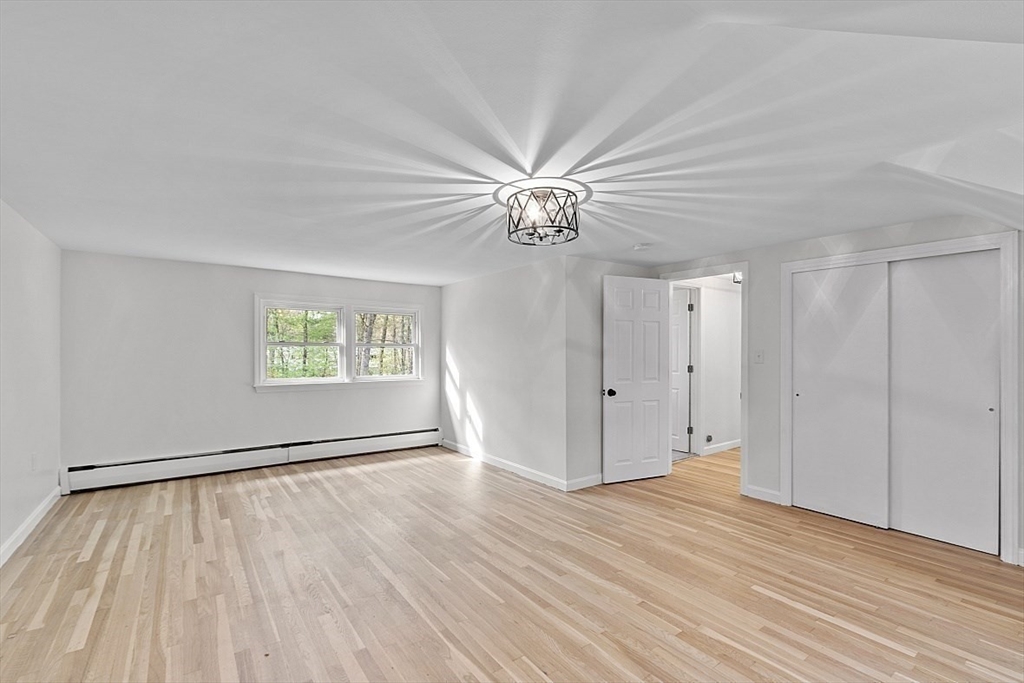 31 Pine Hill Road Chelmsford, MA 01824 - Photo 30 of 42 wooden floor in an empty room with a window