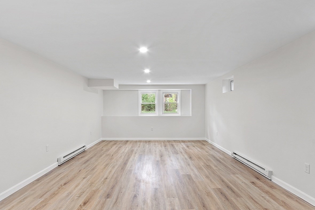 31 Pine Hill Road Chelmsford, MA 01824 - Photo 34 of 42 an empty room with wooden floor and windows