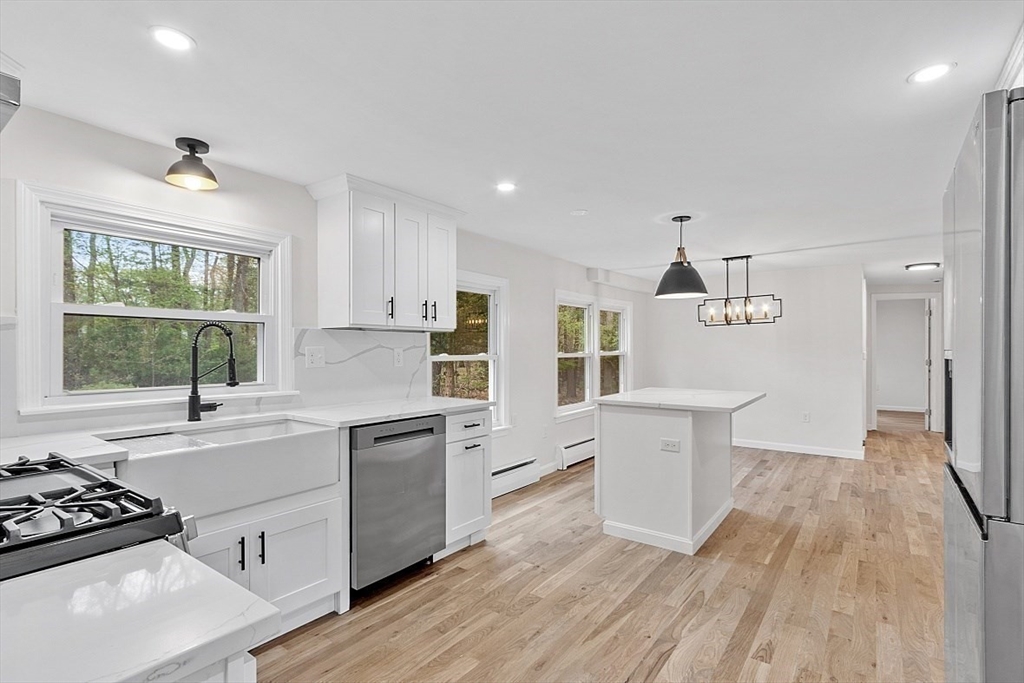 31 Pine Hill Road Chelmsford, MA 01824 - Photo 4 of 42 a kitchen with a sink stove and wooden cabinets