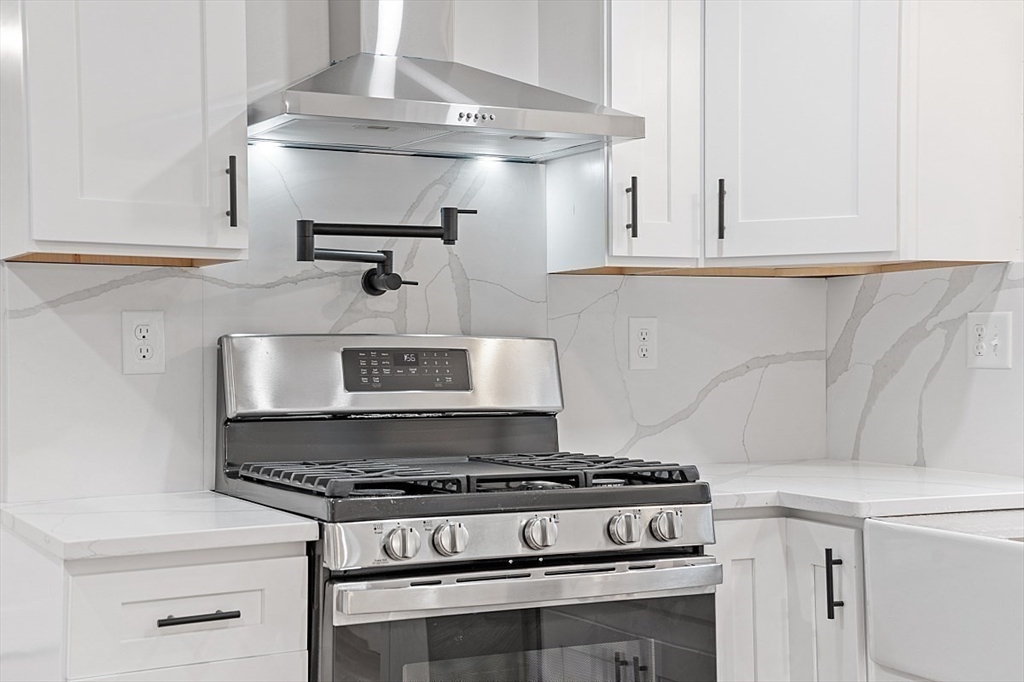 31 Pine Hill Road Chelmsford, MA 01824 - Photo 5 of 42 a stove top oven sitting inside of a kitchen