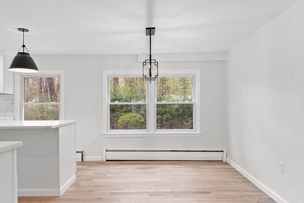 31 Pine Hill Road Chelmsford, MA 01824 - Photo 8 of 42 a view of an empty room with a window and wooden floor