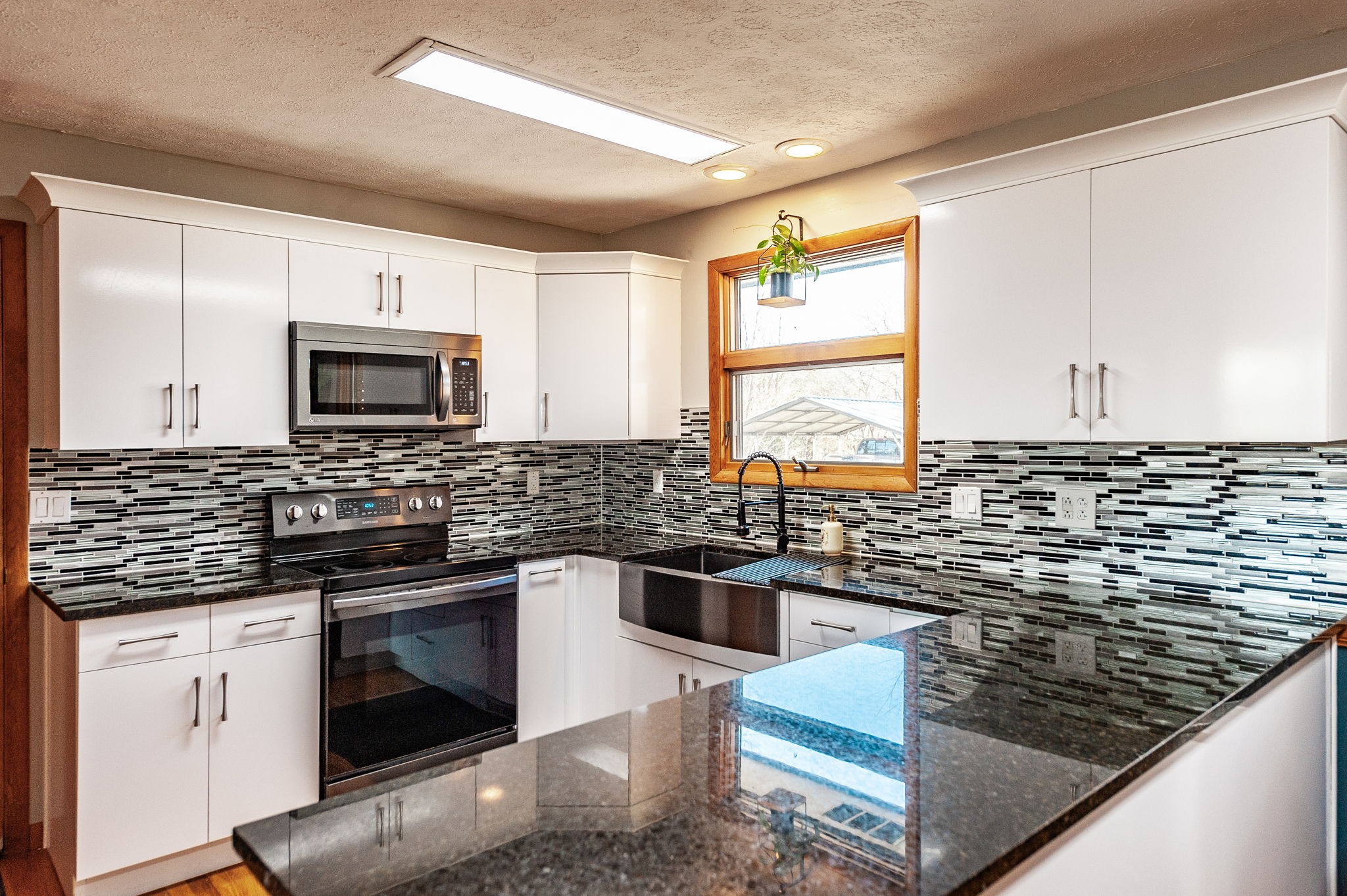705 Ronnie Road Madison, TN 37115 - Photo 13 of 65 a kitchen with stainless steel appliances granite countertop a sink a stove a microwave a counter space and cabinets