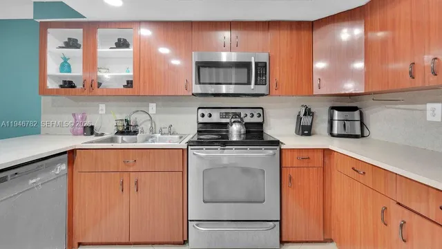 a kitchen with stainless steel appliances granite countertop a sink stove and microwave