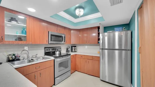 a kitchen with a refrigerator sink and cabinets