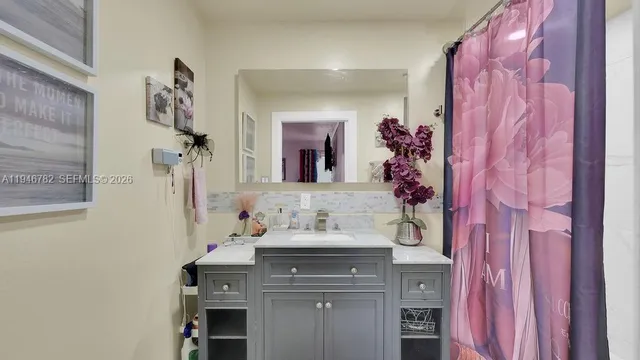 a bathroom with a sink and a mirror