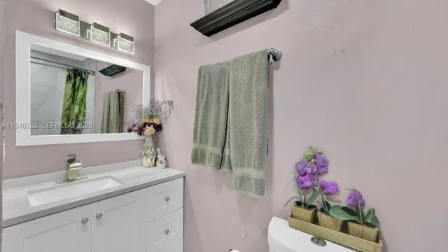 a bathroom with a mirror sink and vanity