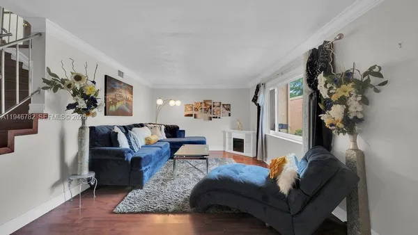 a living room with furniture and a flat screen tv