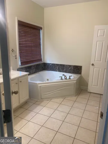 a bathroom with a bathtub and sink