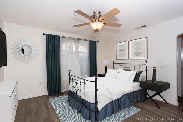 a bed sitting in a bedroom next to a window