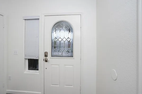 a view of a livingroom with wooden floor and entryway