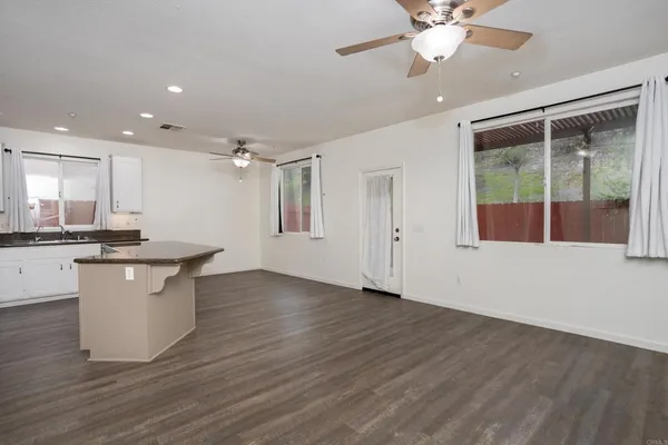 a kitchen with kitchen island a sink stainless steel appliances and cabinets