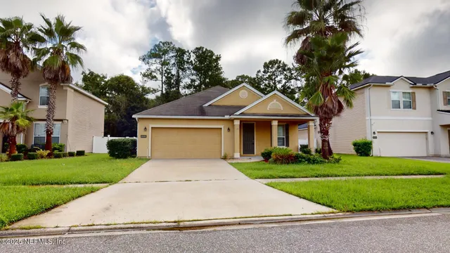 a front view of a house with a yard and garage