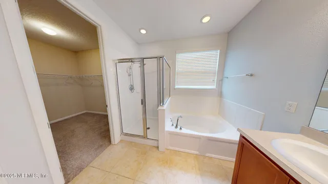 a bathroom with a tub shower and sink