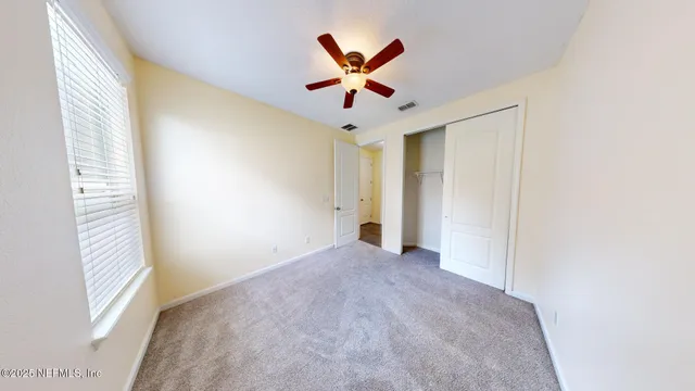a view of livingroom with window and ceiling fan