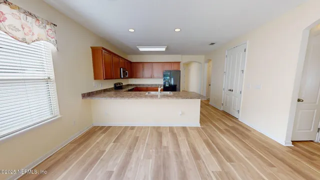 a view of a room with wooden floor and ceiling fan