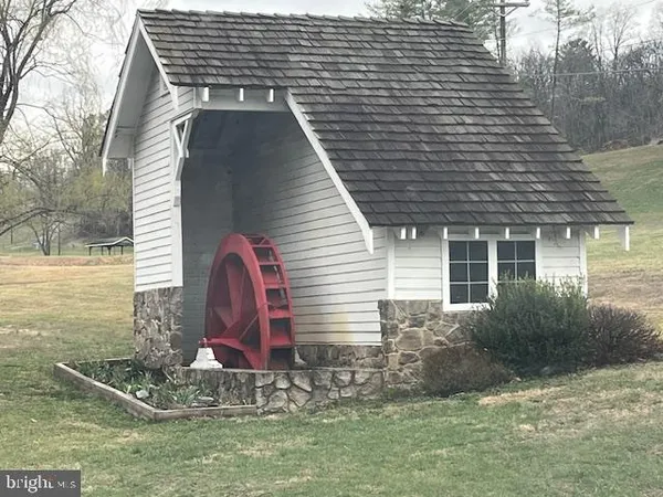 a view of a house with a yard and lake view