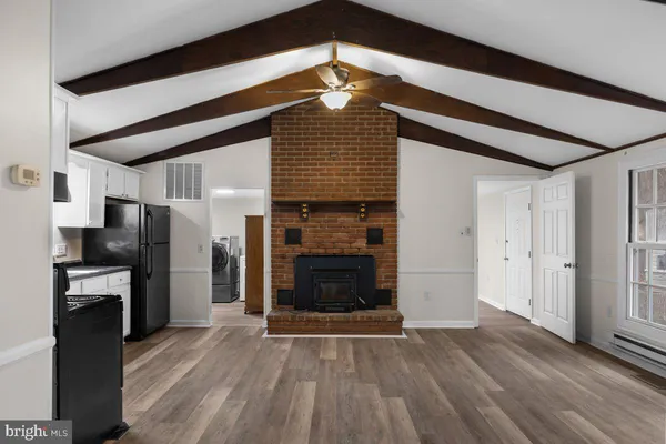 a kitchen with granite countertop a refrigerator stove and sink