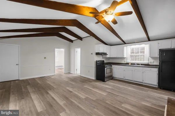 a kitchen with granite countertop a sink stainless steel appliances and cabinets