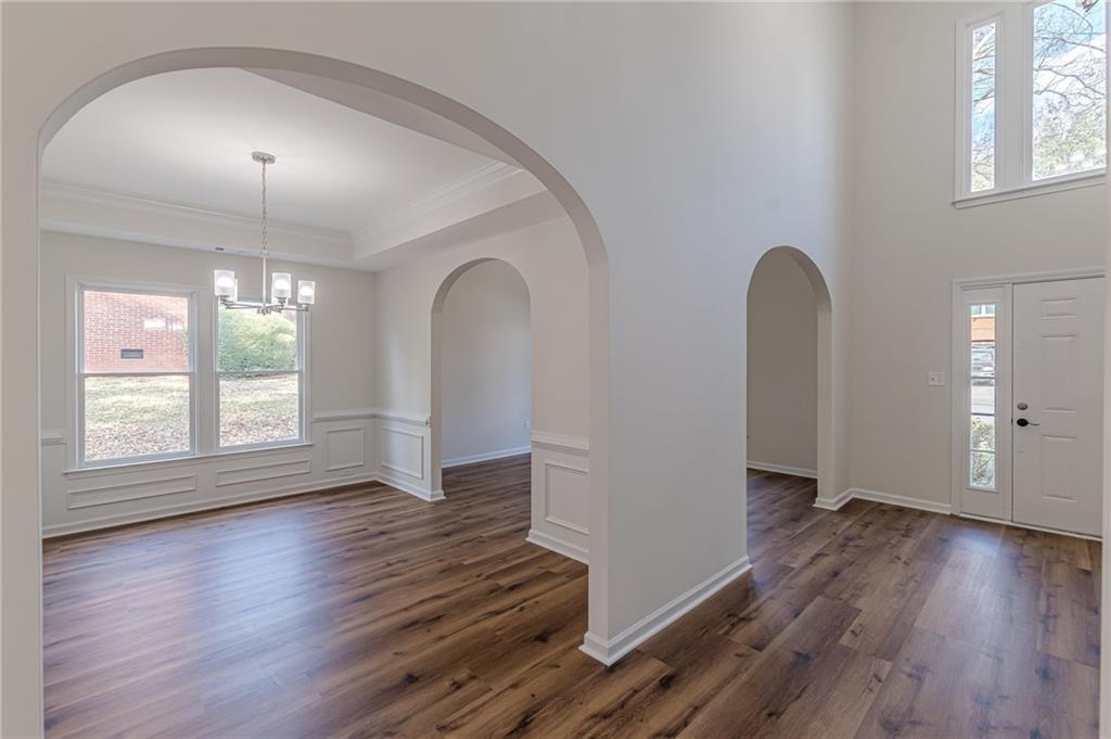 775 Southland Pass Stone Mountain, GA 30087 - Photo 12 of 76 an empty room with wooden floor and windows