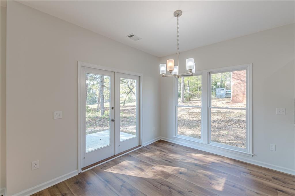 775 Southland Pass Stone Mountain, GA 30087 - Photo 25 of 76 a view of an empty room with wooden floor and a window