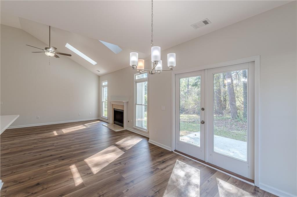 775 Southland Pass Stone Mountain, GA 30087 - Photo 26 of 76 a view of a livingroom with wooden floor a ceiling fan and windows