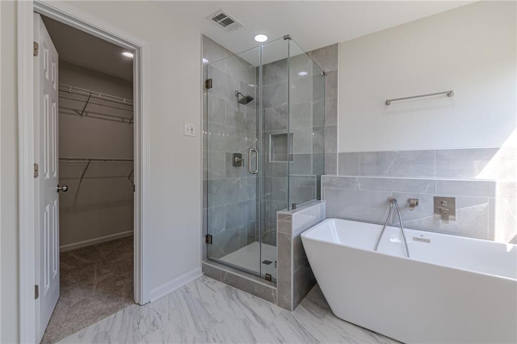 775 Southland Pass Stone Mountain, GA 30087 - Photo 33 of 76 a bathroom with a tub shower and mirror