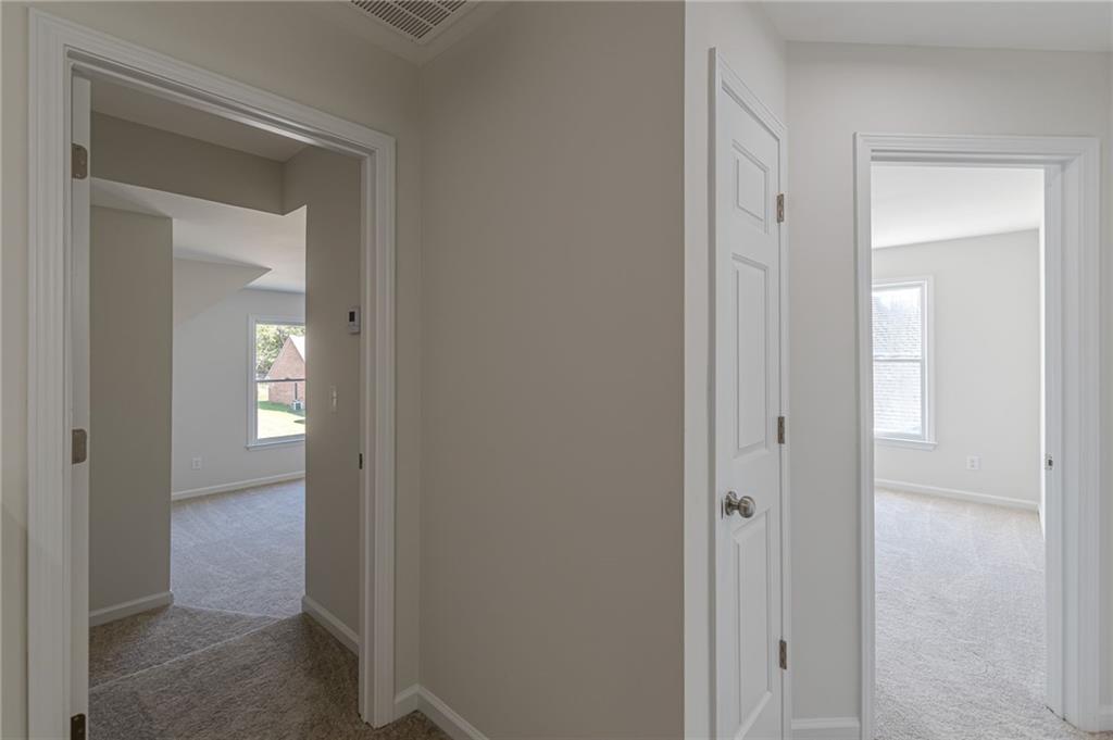 775 Southland Pass Stone Mountain, GA 30087 - Photo 38 of 76 a view of a bathroom from the hallway with toilet