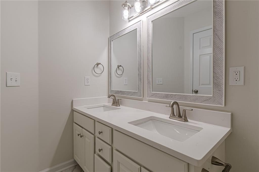 775 Southland Pass Stone Mountain, GA 30087 - Photo 45 of 76 a bathroom with a sink and a mirror