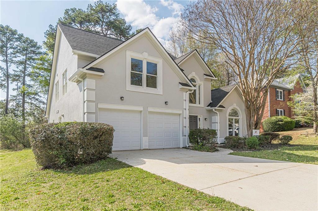 775 Southland Pass Stone Mountain, GA 30087 - Photo 53 of 76 a view of a white house next to a yard with big trees