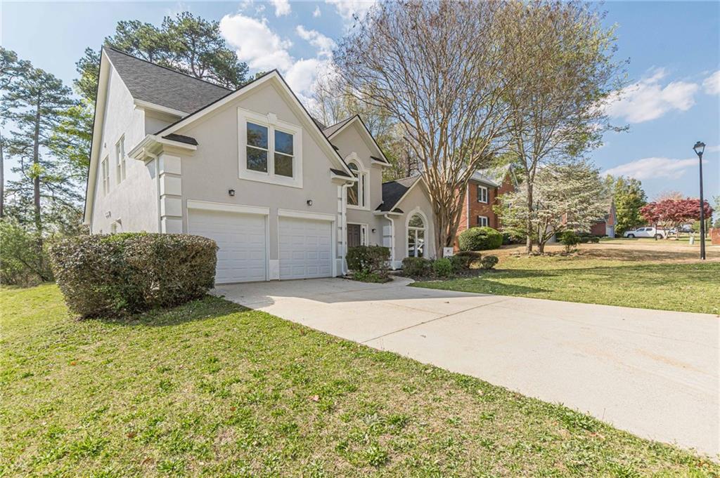 775 Southland Pass Stone Mountain, GA 30087 - Photo 54 of 76 a view of a house with a yard and garage