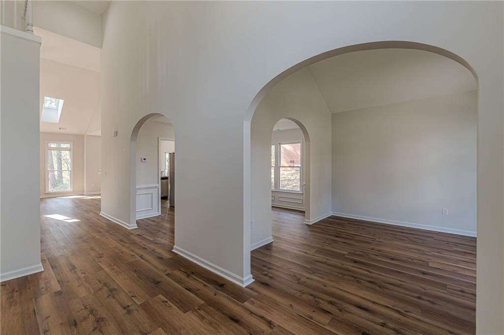 775 Southland Pass Stone Mountain, GA 30087 - Photo 6 of 76 an empty room with wooden floor and windows