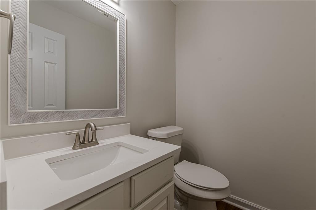 775 Southland Pass Stone Mountain, GA 30087 - Photo 10 of 76 a bathroom with a sink a toilet and mirror