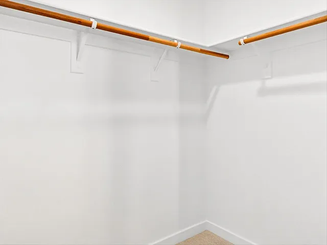 a bathroom with a granite countertop toilet sink and mirror