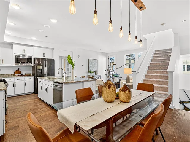 a large kitchen with a table and chairs