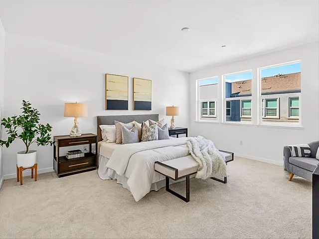 a bedroom with a bed and a lamp