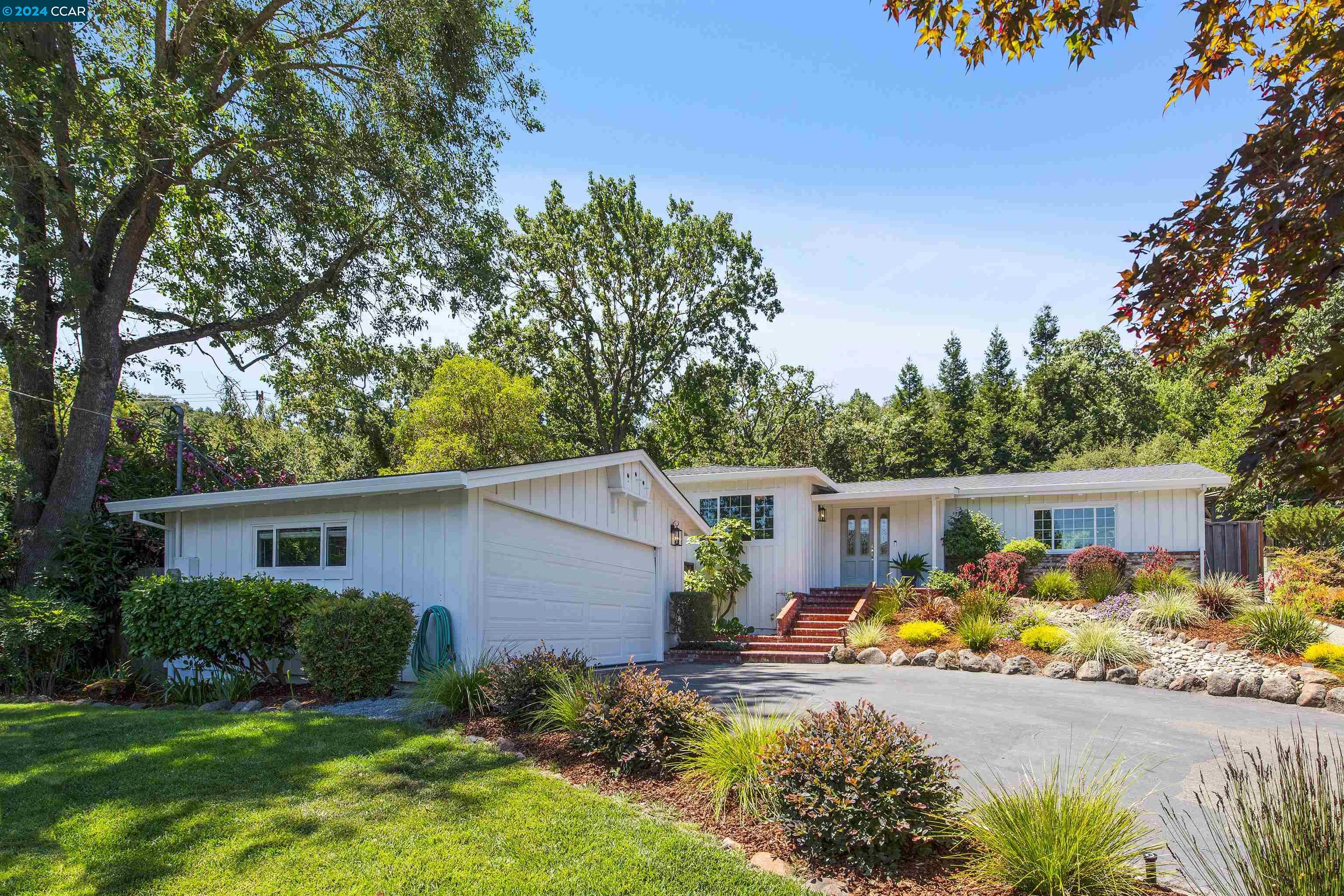 a view of a house with backyard and sitting area