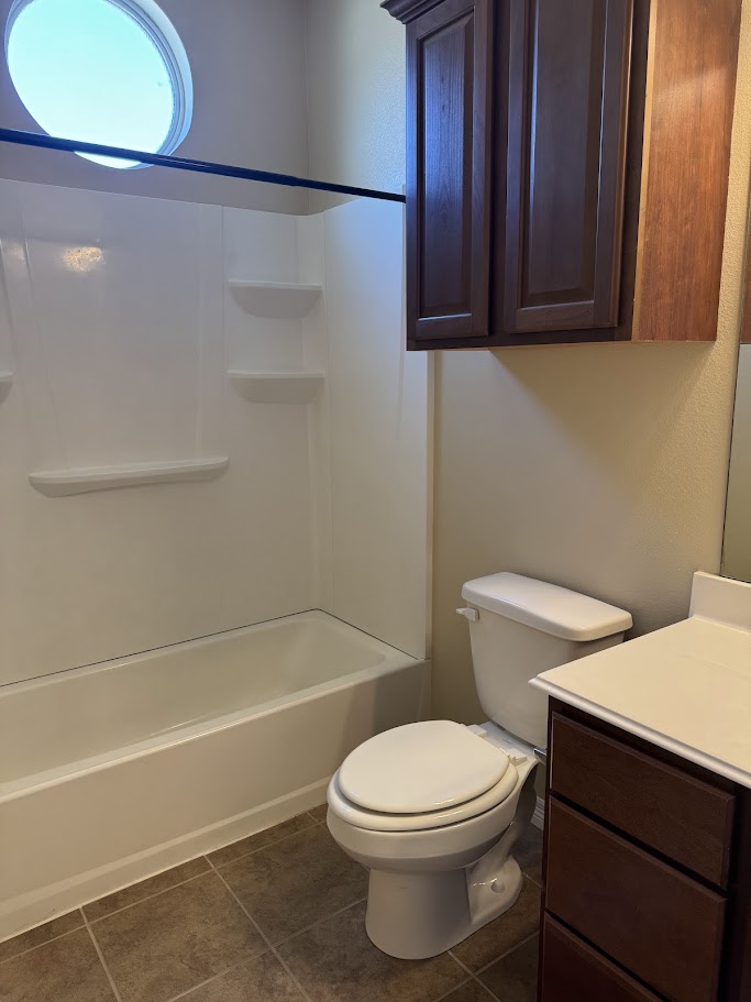 1198 Jones-Butler Road, Unit 1904 College Station, TX 77840 - Photo 10 of 17 Full bathroom featuring vanity, dark tile patterned flooring, and shower / tub combination