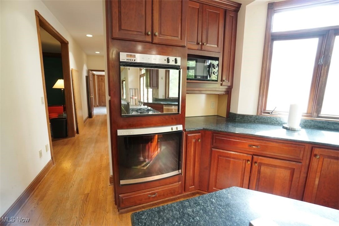 7060 Gates Road Gates Mills, OH 44040 - Photo 10 of 38 Kitchen with light wood-style flooring, multiple ovens, black microwave, dark stone counters, and recessed lighting