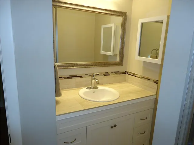 a bathroom with a sink and a mirror
