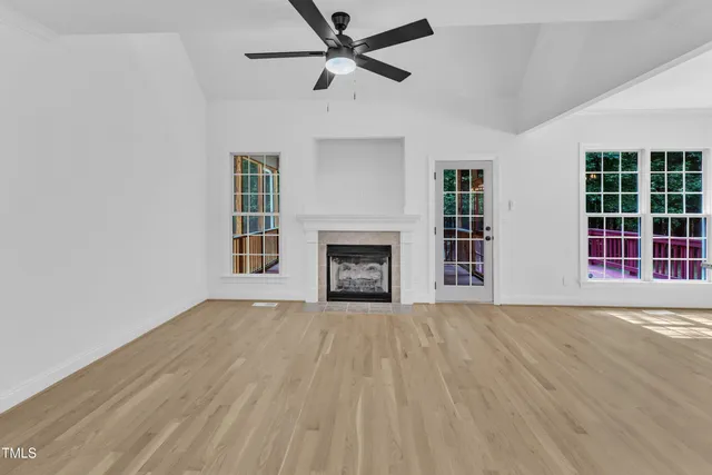 a view of a room with wooden floor and a window