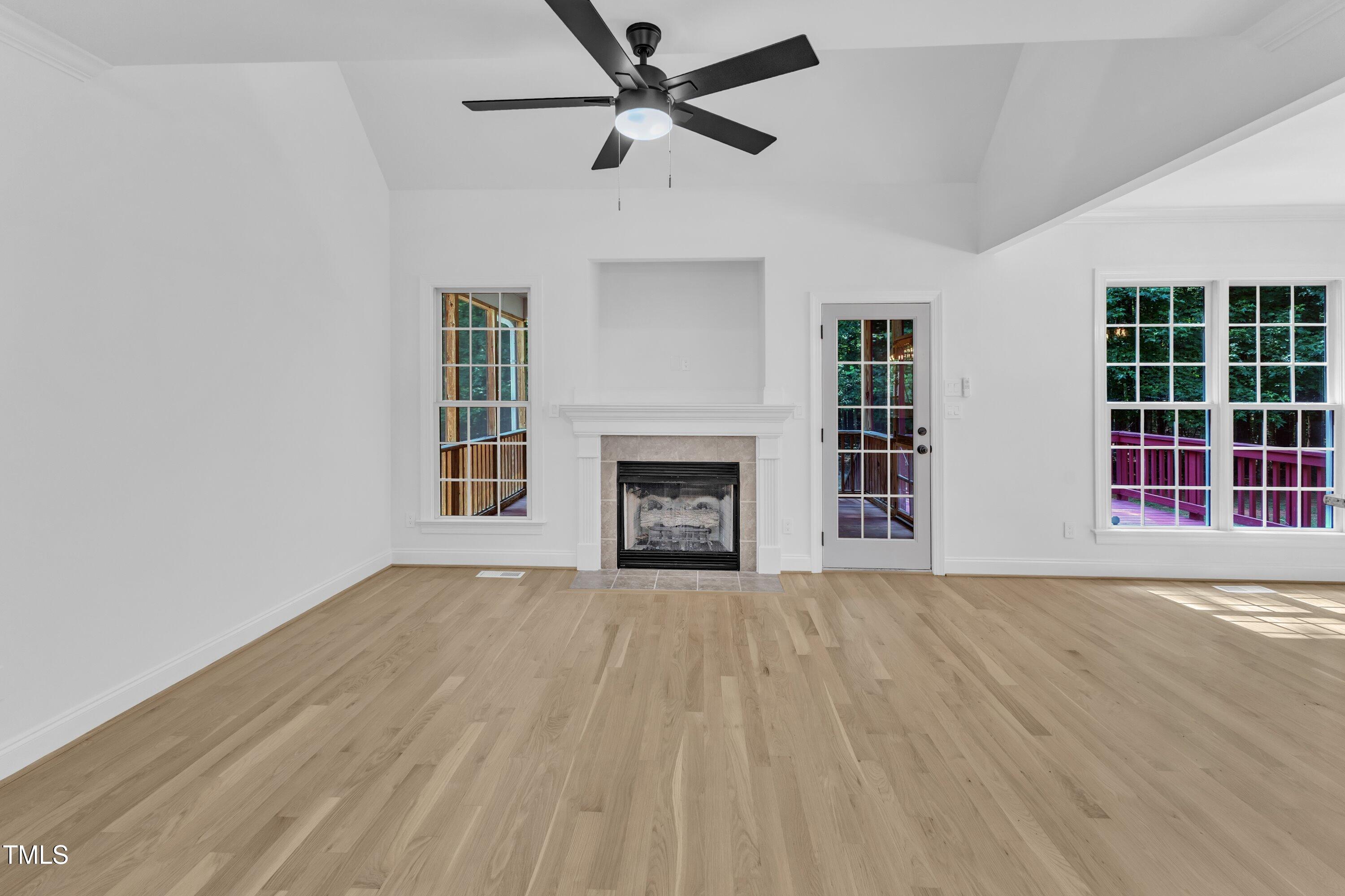 2103 Troys Trail Franklinton, NC 27525 - Photo 11 of 53 a view of an empty room with a fireplace and a window
