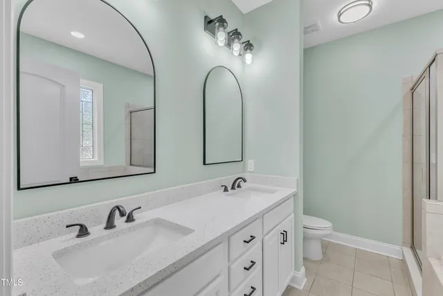 a view of empty room with a fireplace and window