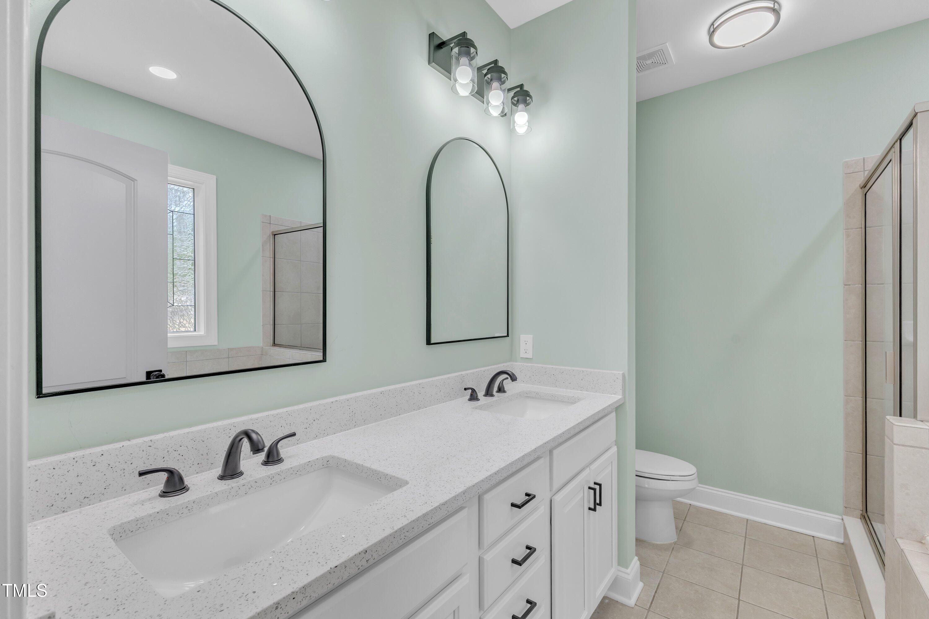 2103 Troys Trail Franklinton, NC 27525 - Photo 12 of 53 a bathroom with a double vanity sink and a mirror